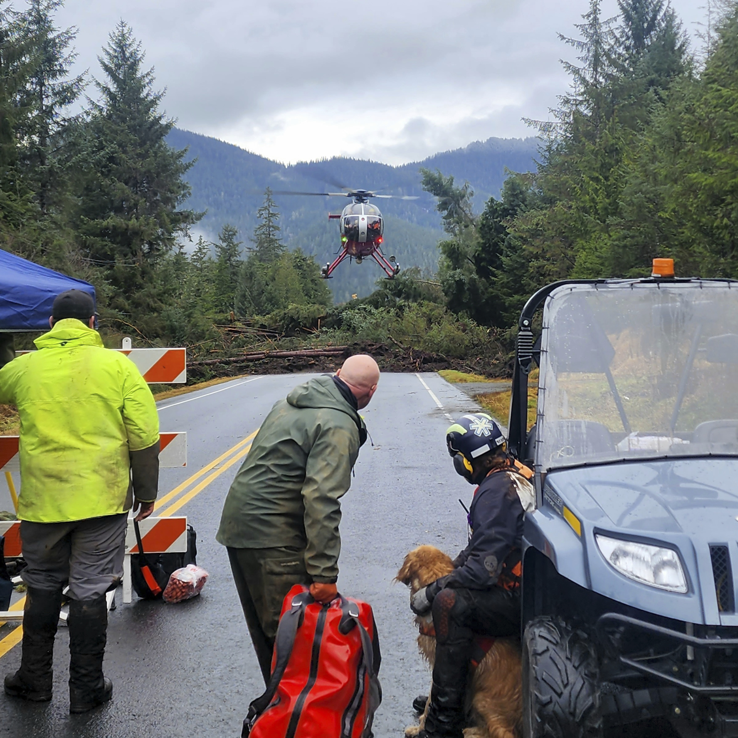 FILE - This photo provided by Division of Homeland Security and Emergency Management shows a helicopter arriving near mile 11 of the Zimovia Highway where ground teams, including search and rescue dogs, work to search areas that state geologists have determined safe for entry Wednesday, Nov. 22, 2023, in Wrangell, Alaska, following a massive landslide. Authorities on Friday, Nov. 24, identified those missing or killed in the Alaska landslide this week as five family members and their neighbor, a commercial fisherman who made a longshot bid for the state's lone seat in the U.S. House last year. (Willis Walunga/Division of Homeland Security and Emergency Management via AP, File)